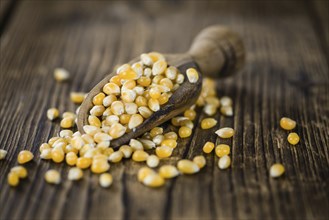 Dried Corn on a wooden table (detailed close-up shot, selective focus)