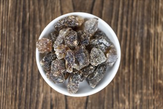 Brown Rock Candy on wooden background (selective focus, close-up shot)