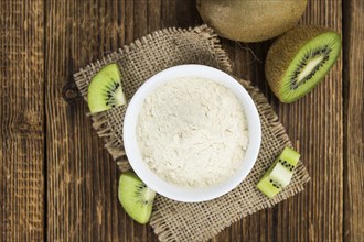 Fresh made Kiwi powder (slective focus, close-up shot) on an old wooden table