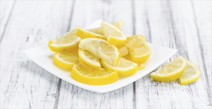 Lemon Slices on a vintage background as detailed close-up shot (selective focus)