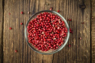 Pink Peppercorns on a vintage background as detailed close-up shot, selective focus