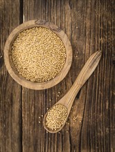 Seeds (Mustard) as high detailed close-up shot on a vintage wooden table (selective focus)