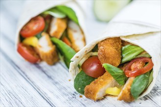 Fresh made Chicken Wraps on an vintage background (selective focus)