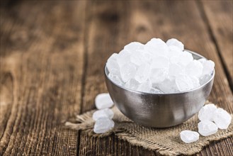 White Rock Candy on wooden background (detailed close-up shot, selective focus)