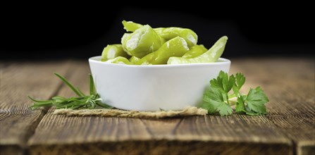 Fresh made Green Chilis (filled with cheese) on a vintage background (close-up shot)