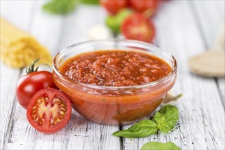 Pasta Sauce (Tomato taste) as high detailed close-up shot on a vintage wooden table (selective