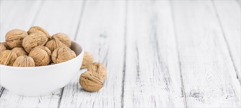 Walnuts on a vintage background as detailed close-up shot (selective focus)