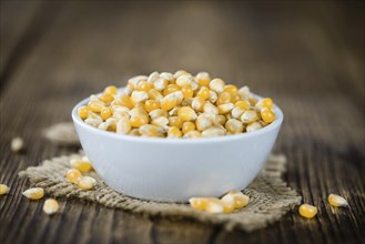 Wooden table with a portion of Corn (selective focus, close-up shot)