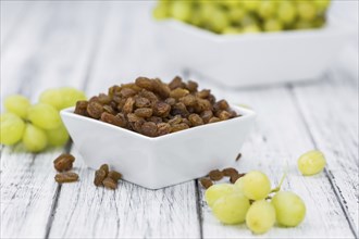 Vintage wooden table with Raisins (selective focus, close-up shot)