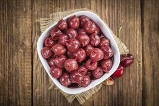Fresh made Canned Cherries on a vintage background as detailed close-up shot