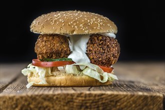 Falafel Burger (close-up shot, selective focus) on wooden background