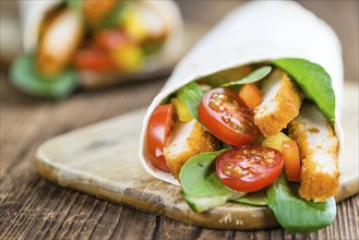 Fresh made Chicken Wraps on an vintage background (selective focus)