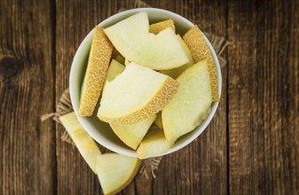 Honeydew Melon on a vintage background as detailed close-up shot (selective focus)