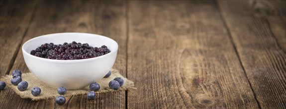 Homemade Preserved Blueberries on an wooden table as detailed close-up shot, selective focus