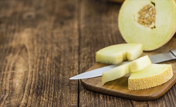 Fresh made Honeydew Melon on a vintage background (close-up shot)