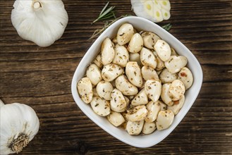 Portion of fresh Preserved Garlic (close-up shot, selective focus)