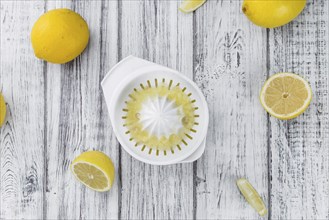 Homemade Lemon Juice on an wooden table (selective focus) as detailed close-up shot