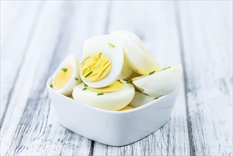 Wooden table with halved Eggs (selective focus, close-up shot)