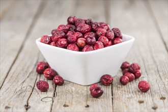 Dried Cranberries on an old wooden table (selective focus)