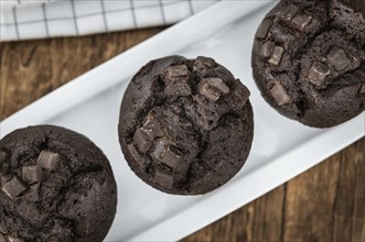 Fresh Chocolate Muffins as detailed close-up shot (selective focus)