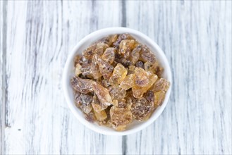 Brown Rock Candy on wooden background (selective focus, close-up shot)