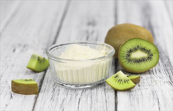 Fresh made Kiwi powder (slective focus, close-up shot) on an old wooden table