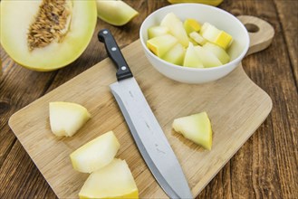 Honeydew Melon on an old wooden table as detailed close-up shot (selective focus)