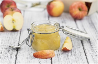 Portion of fresh made Applesauce (selective focus) on a wooden table