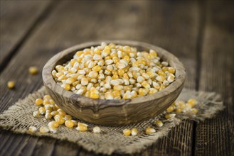 Portion of Corn (detailed close-up shot) on wooden background (selective focus)