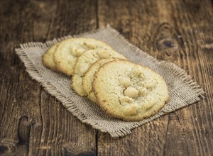 Wooden table with Cookies (detailed close-up shot, selective focus)