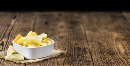 Homemade Lemon Slices on an wooden table (selective focus) as detailed close-up shot