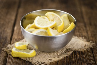 Fresh made Lemon (sliced) on a vintage background (close-up shot)