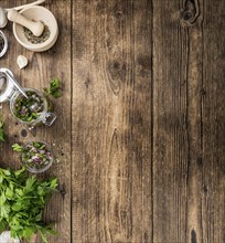 Healthy homemade Chimichurri on a wooden table as detailed close-up shot (selective focus)