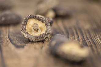 Homemade Dried Shiitake on an wooden table as detailed close-up shot, selective focus