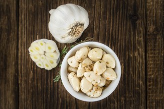 Fresh made Garlic (preserved) on a vintage background (close-up shot)