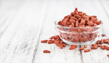 Fresh made Dried Goji Berries on a vintage background (close-up shot)