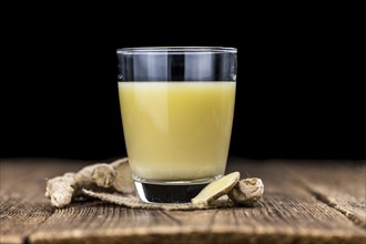 Portion of healthy Ginger Drink (selective focus, close-up shot)