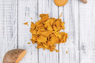 Homemade Sweet Potato Chips on vintage background selective focus, close-up shot