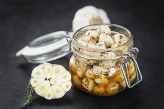 Fresh made Garlic (preserved) on a vintage background (close-up shot)