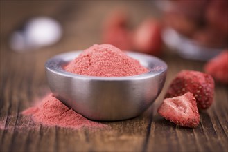 Fresh made Strawberry powder on a vintage background as detailed close-up shot