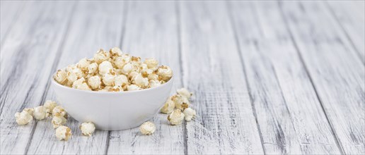 Fresh made Popcorn on an old and rustic wooden table, selective focus, close-up shot