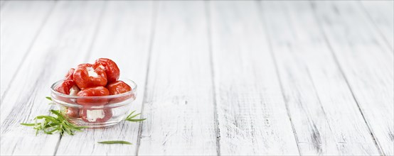 Fresh made Red Pepper (stuffed with cheese) on an old and rustic wooden table (selective focus,