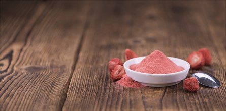 Fresh made Strawberry powder on a vintage background as detailed close-up shot