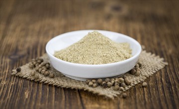 Fresh made White Pepper on a vintage background as detailed close-up shot