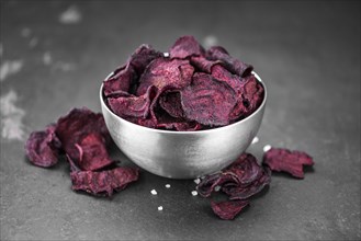 Portion of healthy Beetroot Chips on a slate slab (selective focus)