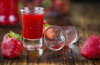 Some homemade Strawberry liqueur as detailed close-up shot, selective focus