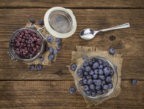 Preserved Blueberries on a vintage background as detailed close-up shot, selective focus