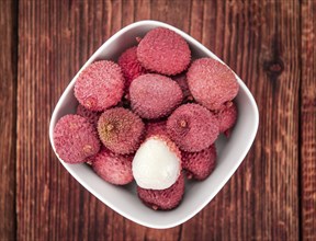 Lychees on a vintage background as detailed close-up shot (selective focus)