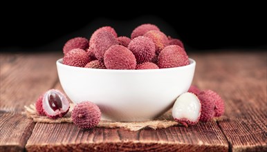 Lychees on a vintage background as detailed close-up shot (selective focus)