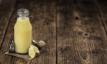 Portion of healthy Ginger Drink (selective focus, close-up shot)